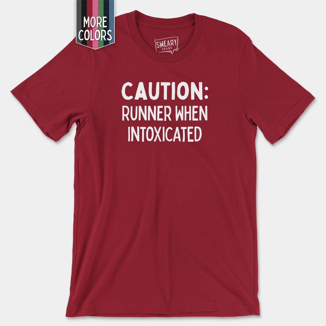 a red shirt that says caution runner when intoxicated