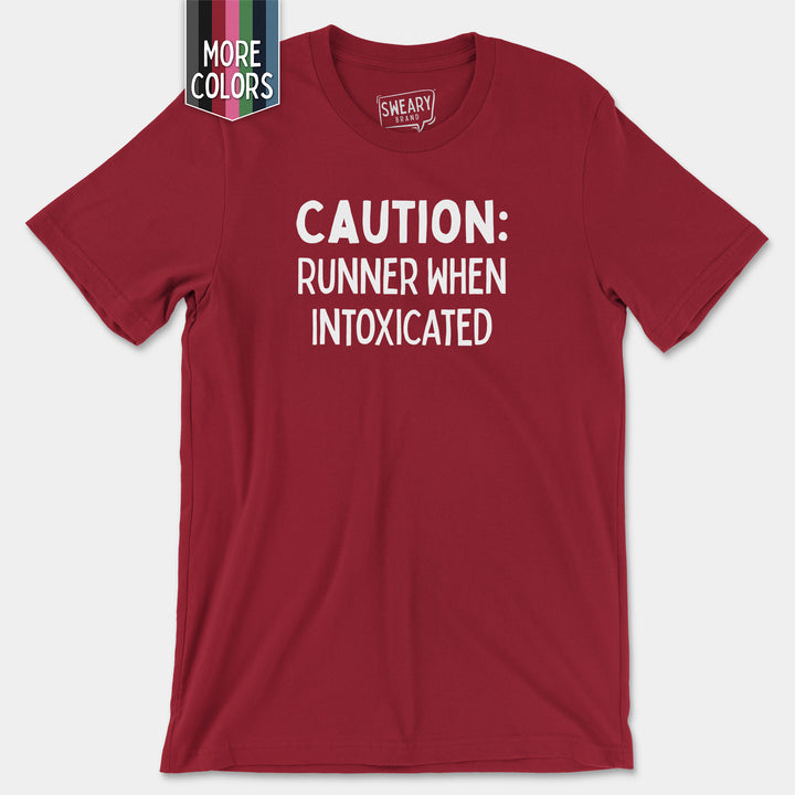 a red shirt that says caution runner when intoxicated