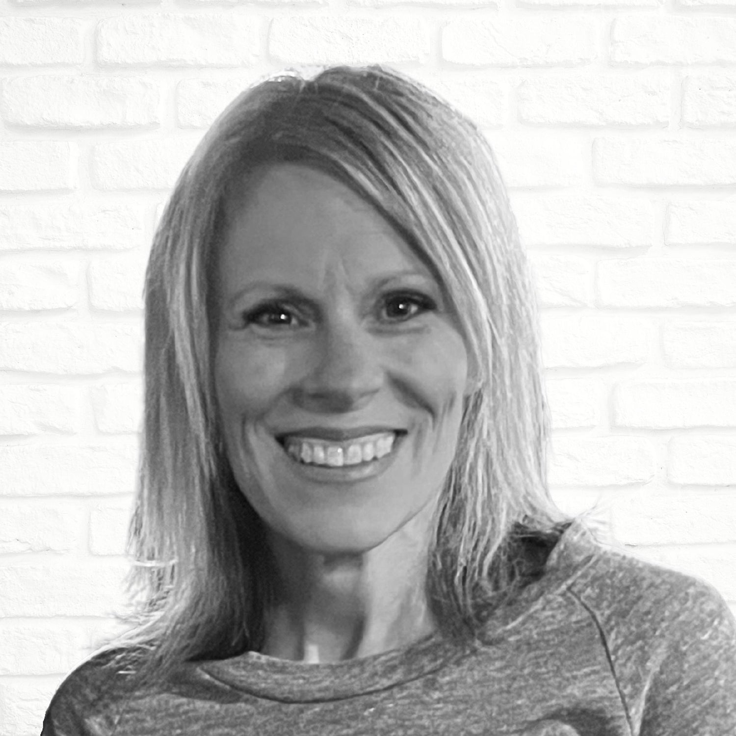 black and white photo of woman smiling, Jeannie Corsini, Founder of Sweary Brand