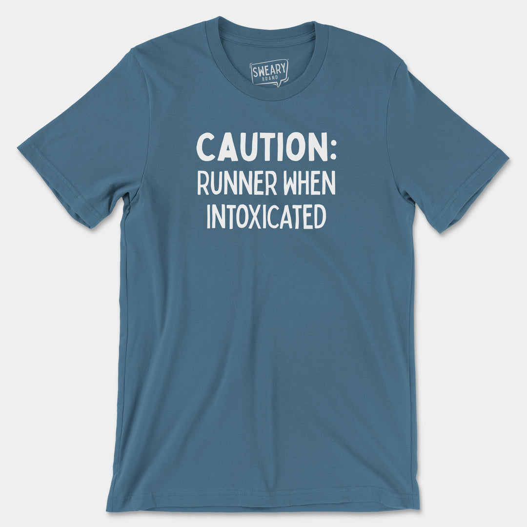 a blue shirt that says caution runner when intoxicated