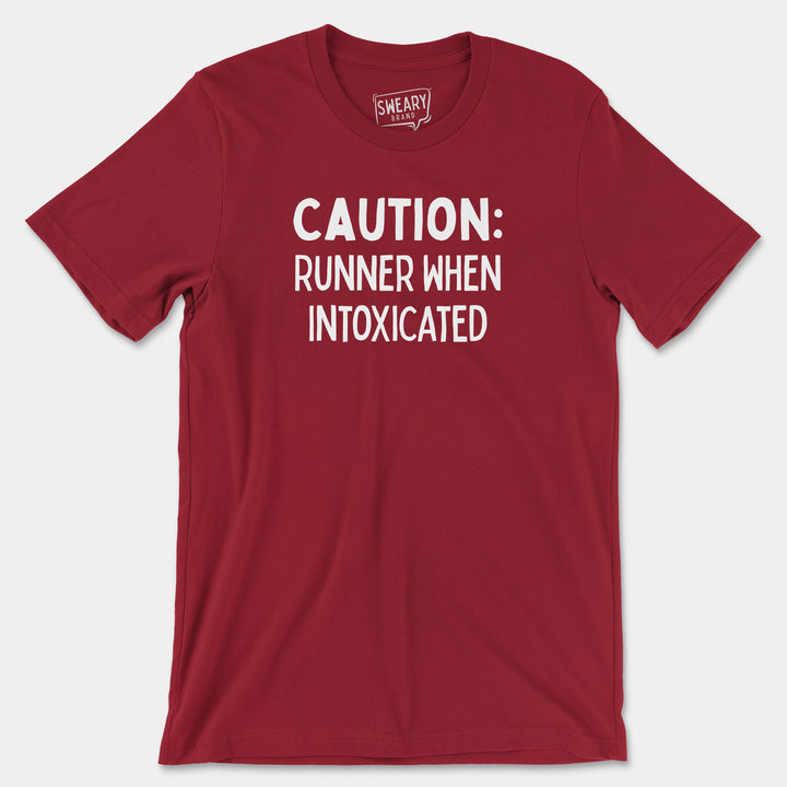 a red shirt that says caution runner when intoxicated